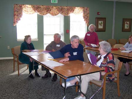 A Genealogical Society member discusses genealogy with Friends Village residents.