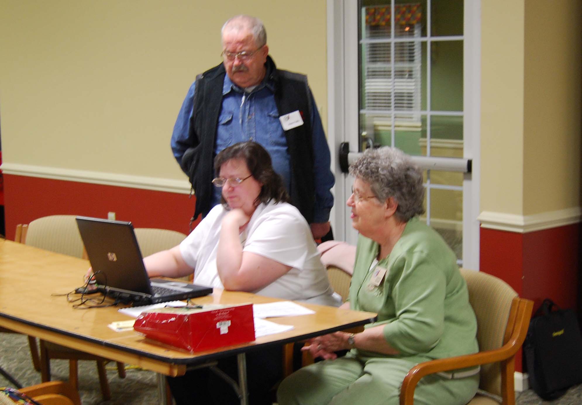 Members assist each other with learning new ways of searching for ancestors through the internet