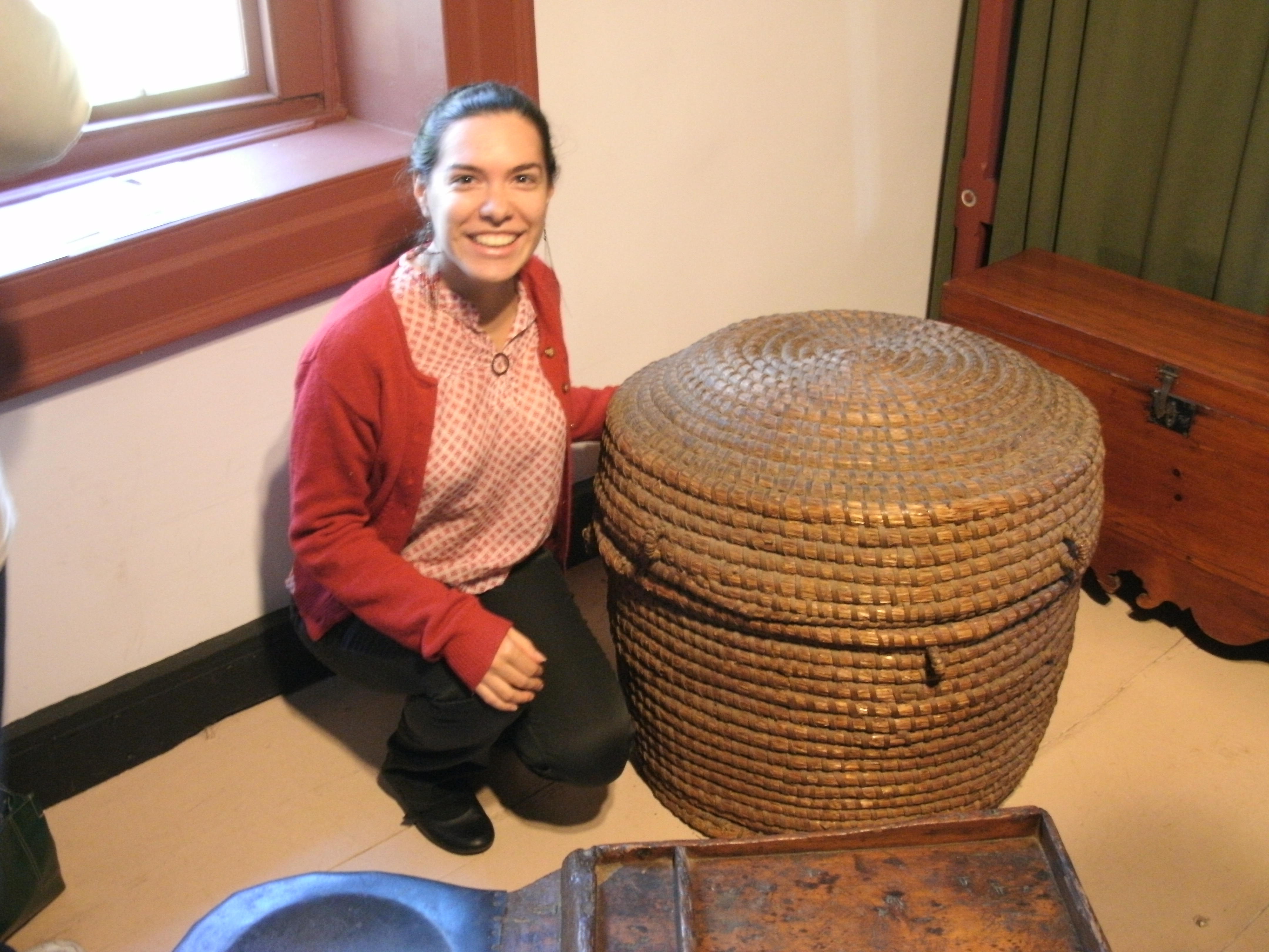 Bonny Beth Elwell poses with a basket said to have come with her ancestor on the ship to America